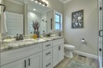 Master bathroom with a double vanity and a large tile shower with glass doors